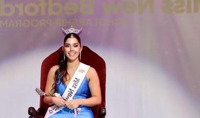 Emma Gendreau wears a crown sitting in a chair with a Miss New Bedford sash on