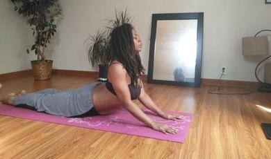 Johanne Barthold practices yoga in front of a mirror.